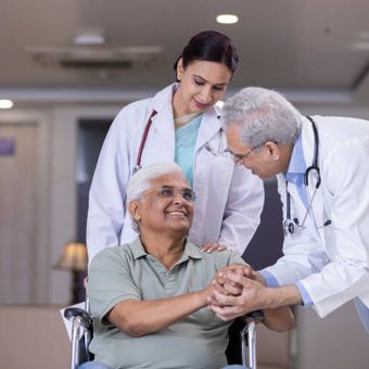 Doctors caring for a smiling senior patient